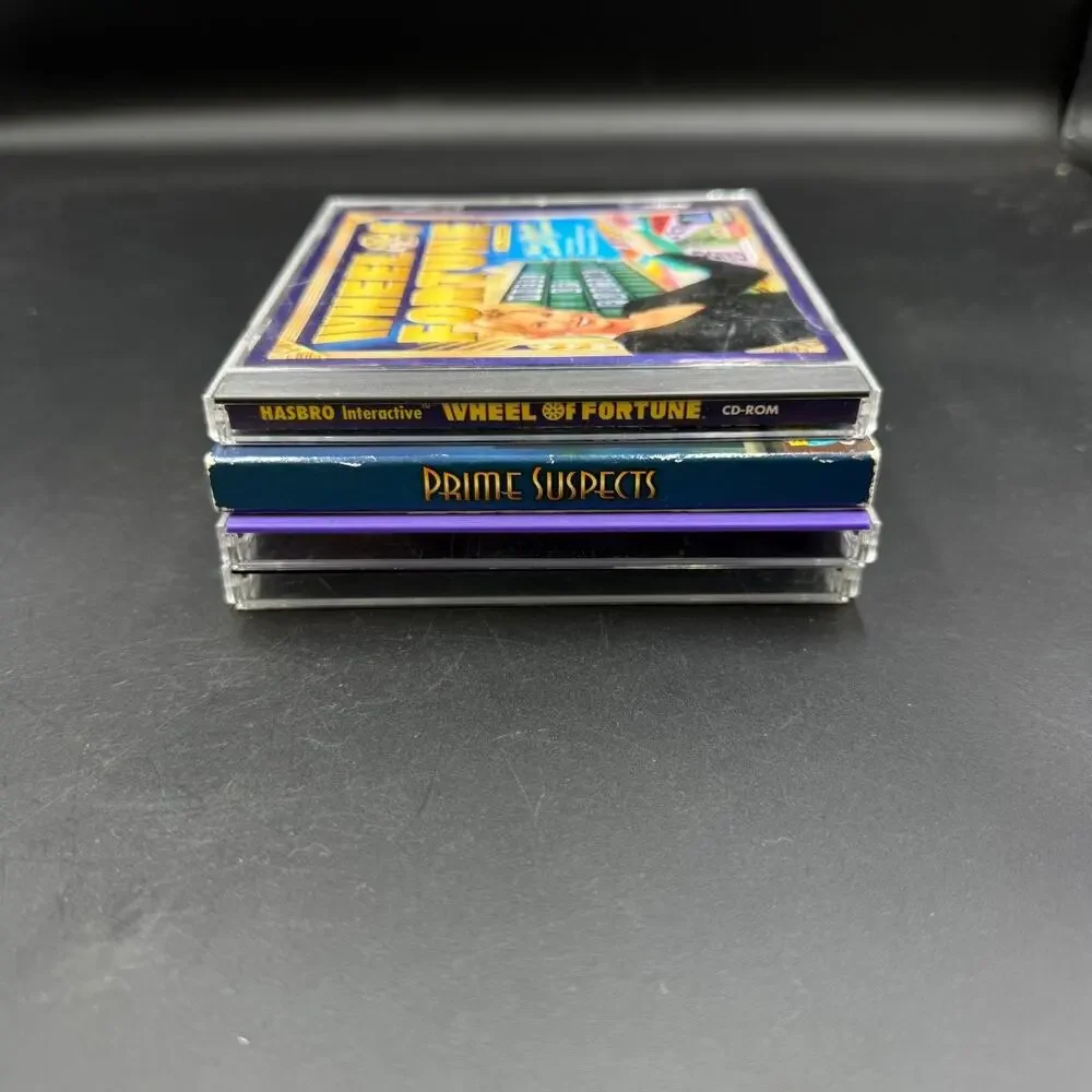 PC Mixed Game Lot of 4 Solitaire Wheel of Fortune Prime Suspects Trophy Bass